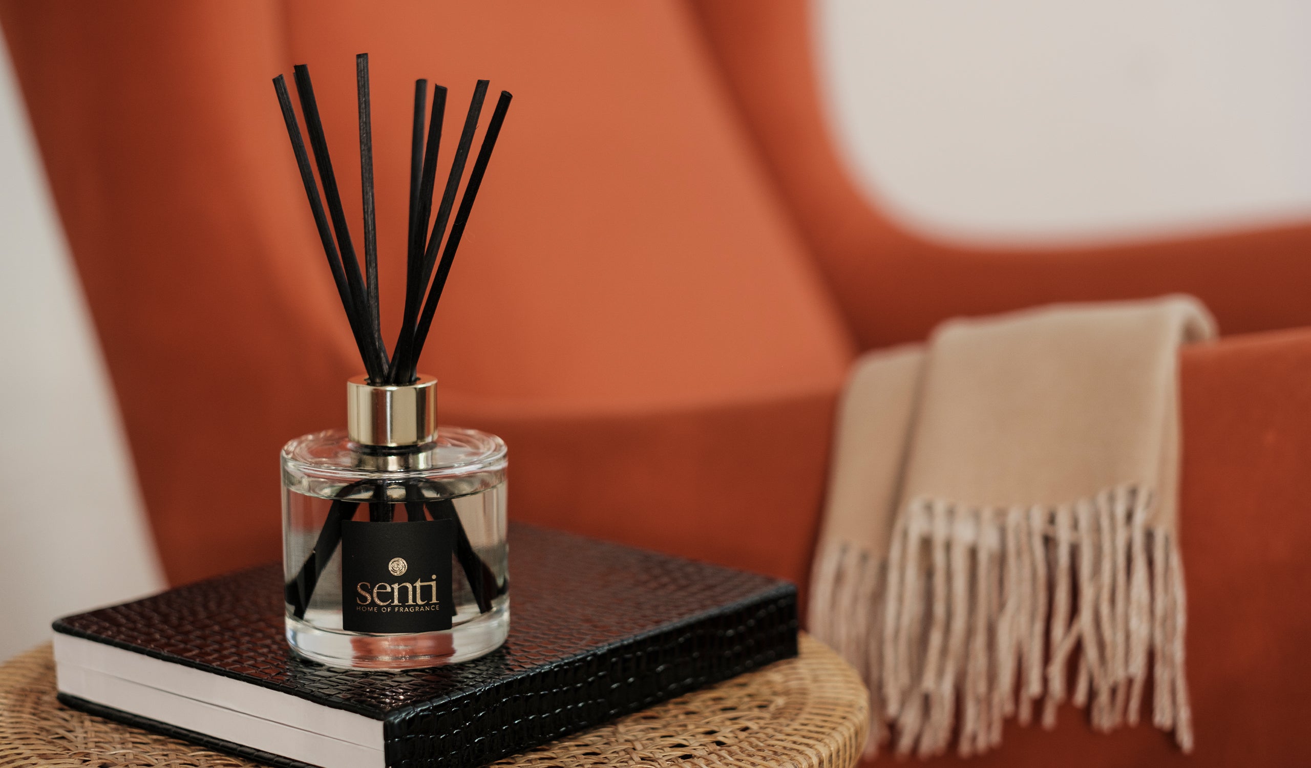 Our fragrances - image of a little Senti reed diffuser in a warm home