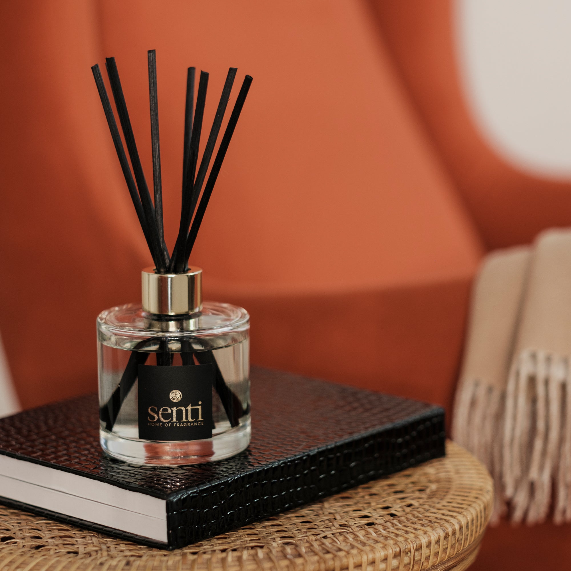 Our fragrances - image of a little Senti reed diffuser in a warm home